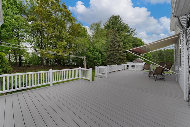 96 Grove St, Lewiston, ME 04240 - wooden deck featuring outdoor dining space and view of wooded area