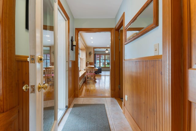 96 Grove St, Lewiston, ME 04240 - hallway with a wainscoted wall, french doors, and light tile patterned floors