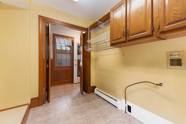 96 Grove St, Lewiston, ME 04240 - laundry room featuring cabinet space, a baseboard radiator, baseboards, and light tile patterned floors