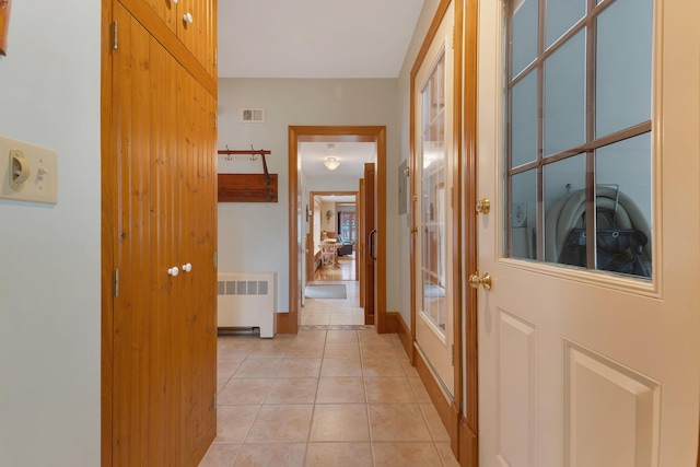 96 Grove St, Lewiston, ME 04240 - hallway with radiator heating unit, light tile patterned floors, french doors, and baseboards