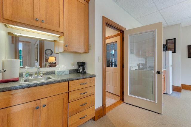 96 Grove St, Lewiston, ME 04240 - kitchen with a sink, freestanding refrigerator, dark countertops, light colored carpet, and a drop ceiling