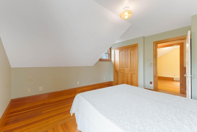 96 Grove St, Lewiston, ME 04240 - bedroom with lofted ceiling, light wood finished floors, a closet, and baseboards