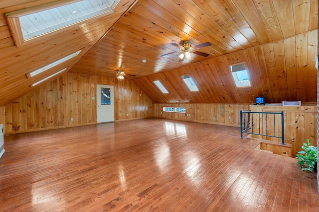 96 Grove St, Lewiston, ME 04240 - additional living space featuring a skylight, wooden walls, light wood-style flooring, a ceiling fan, and vaulted ceiling
