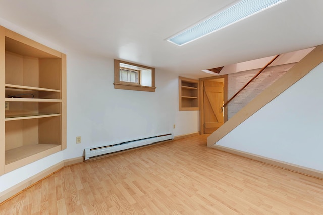 96 Grove St, Lewiston, ME 04240 - unfurnished living room with a baseboard radiator, wood finished floors, baseboards, and stairway