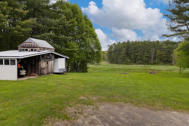 96 Grove St, Lewiston, ME 04240 - view of grassy yard with an outbuilding, a forest view, and a barn