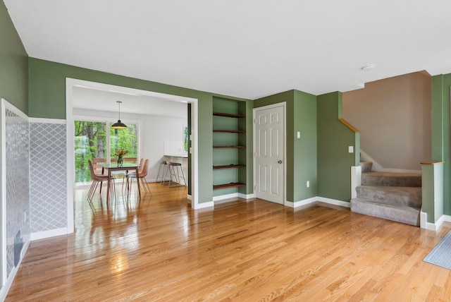 17 Graham Rd Unit 17, Westbrook, ME 04092 - unfurnished living room featuring light wood-style flooring, stairway, built in features, and baseboards