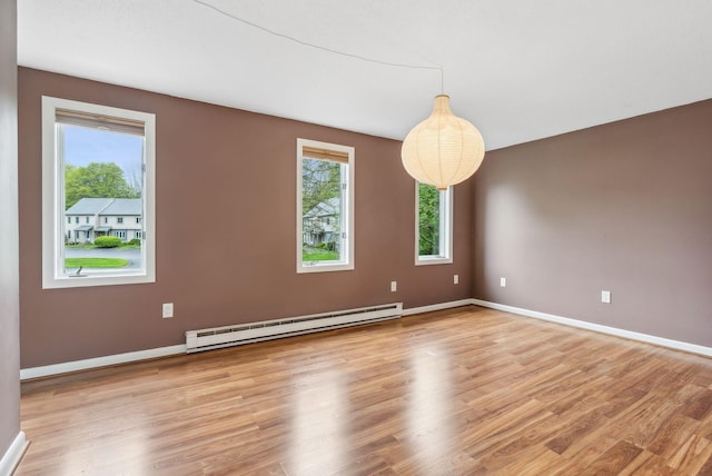 17 Graham Rd Unit 17, Westbrook, ME 04092 - unfurnished room featuring a baseboard heating unit, light wood-style floors, and baseboards