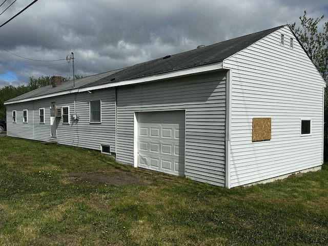 29 Exchange St, Presque Isle, ME 04769 - view of side of property featuring a garage, a chimney, and a lawn