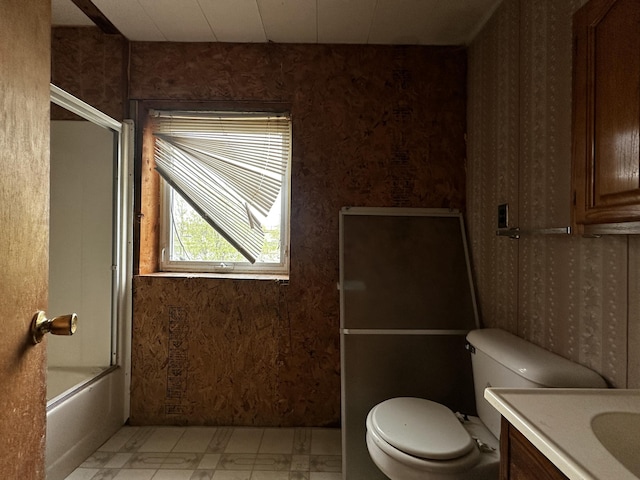 29 Exchange St, Presque Isle, ME 04769 - full bath featuring tile patterned floors, wallpapered walls, toilet, vanity, and bath / shower combo with glass door
