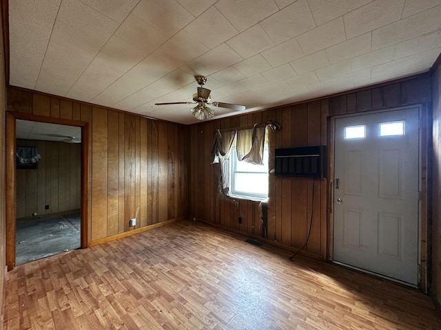 29 Exchange St, Presque Isle, ME 04769 - foyer with ceiling fan, light wood finished floors, baseboards, and wooden walls