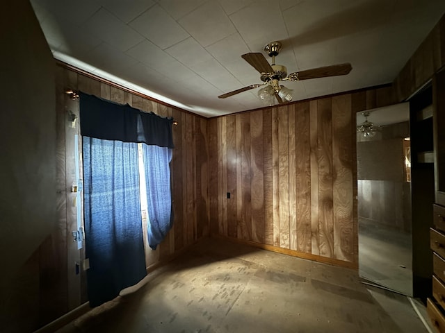 29 Exchange St, Presque Isle, ME 04769 - unfurnished room with wooden walls, baseboards, and a ceiling fan