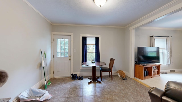 17 Wellman St, Lewiston, ME 04240 - dining area with crown molding, a textured ceiling, baseboards, and light tile patterned flooring