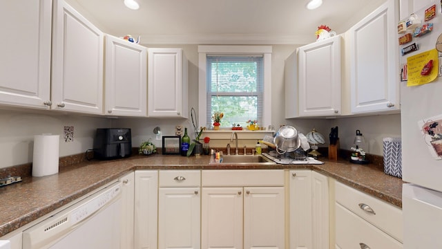 17 Wellman St, Lewiston, ME 04240 - kitchen with a sink, white appliances, white cabinetry, dark countertops, and recessed lighting