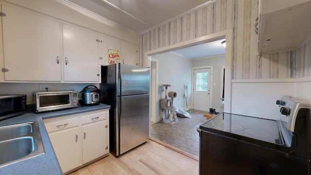 17 Wellman St, Lewiston, ME 04240 - kitchen featuring appliances with stainless steel finishes, ornamental molding, a sink, wallpapered walls, and light wood-style flooring