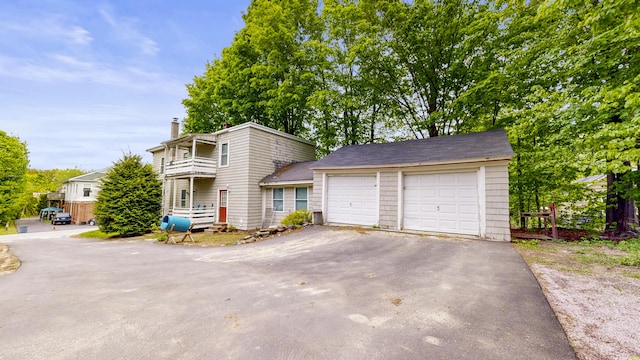 17 Wellman St, Lewiston, ME 04240 - view of front of property featuring a chimney, a balcony, and a garage