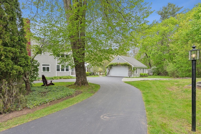 71 N St, Kennebunkport, ME 04046 - view of front of home with a garage, a front yard, and curved driveway