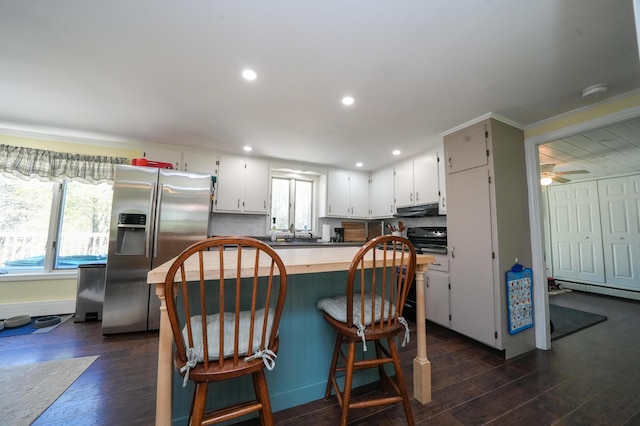 22 Meadow Rd, Hampden, ME 04444 - kitchen with stainless steel fridge, under cabinet range hood, dark wood-style flooring, white cabinets, and recessed lighting