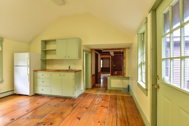 306 Campbell Rd, Leeds, ME 04263 - kitchen featuring green cabinetry, freestanding refrigerator, a sink, vaulted ceiling, and light wood-style flooring