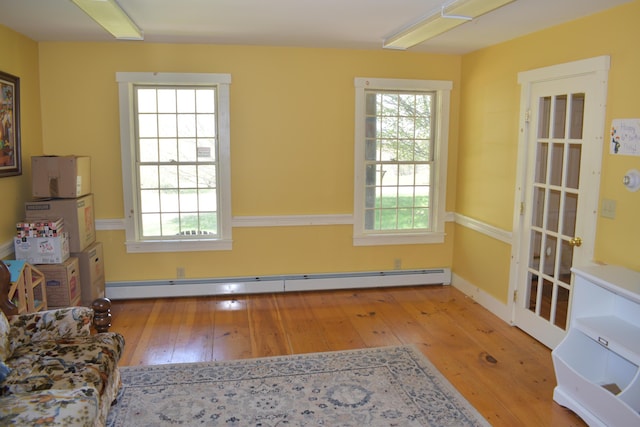 306 Campbell Rd, Leeds, ME 04263 - spare room featuring wood-type flooring, a baseboard heating unit, and healthy amount of natural light