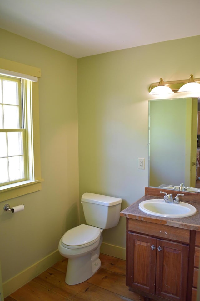 306 Campbell Rd, Leeds, ME 04263 - bathroom featuring toilet, hardwood / wood-style flooring, vanity, and baseboards