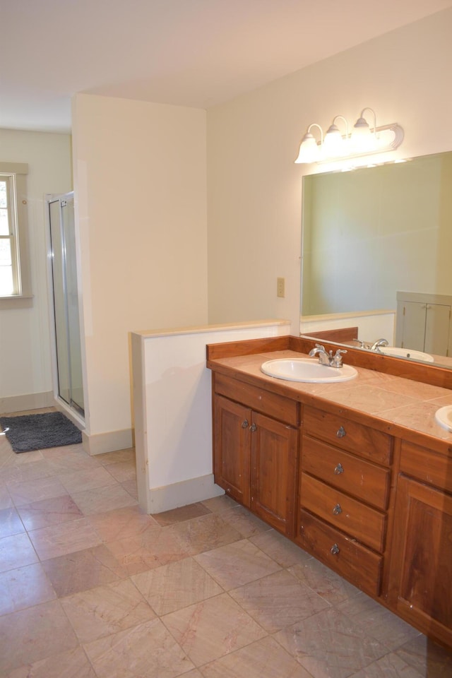 306 Campbell Rd, Leeds, ME 04263 - bathroom featuring a stall shower, double vanity, and baseboards