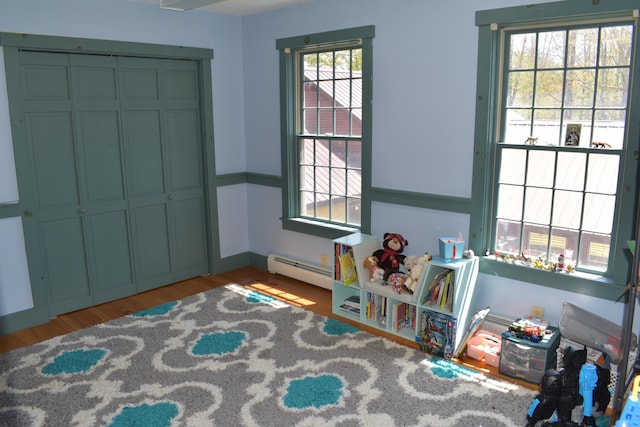 306 Campbell Rd, Leeds, ME 04263 - recreation room featuring a baseboard radiator and wood finished floors