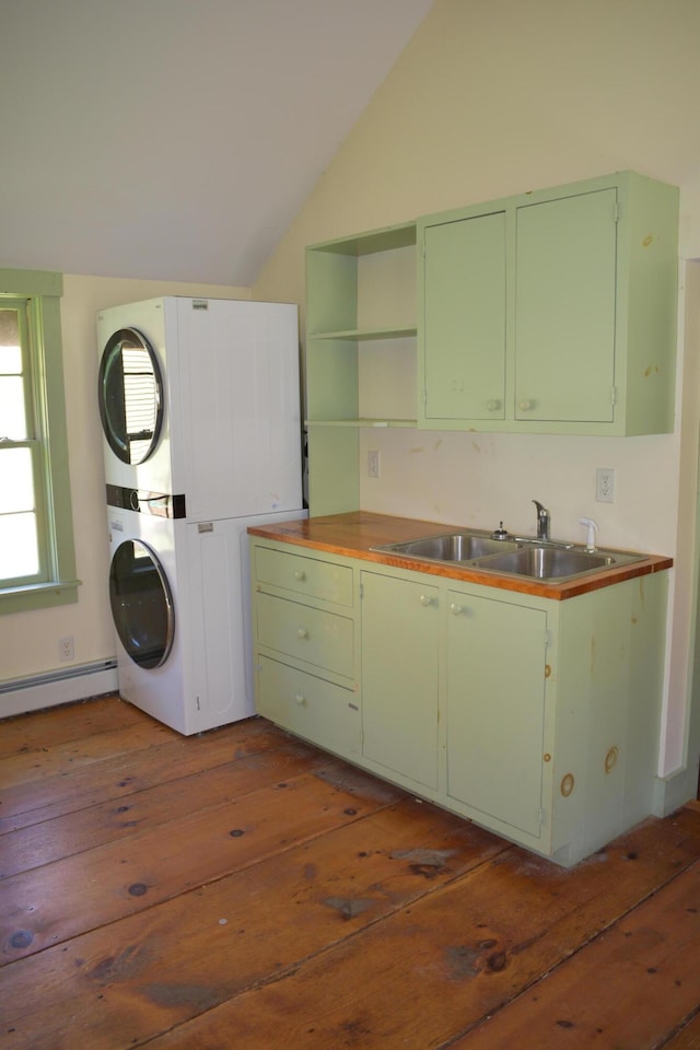 306 Campbell Rd, Leeds, ME 04263 - washroom with a baseboard radiator, stacked washing machine and dryer, and dark wood-type flooring