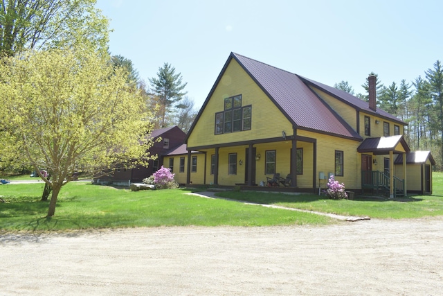 306 Campbell Rd, Leeds, ME 04263 - view of front of property featuring a front lawn, metal roof, and covered porch