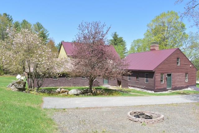 306 Campbell Rd, Leeds, ME 04263 - view of front of house featuring a fire pit, a chimney, and metal roof