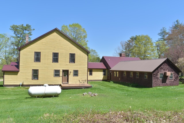 306 Campbell Rd, Leeds, ME 04263 - back of property featuring a wooden deck, a yard, and a chimney