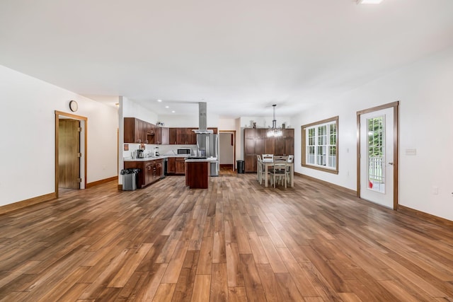 66 Mcnally Rd, Clinton, ME 04927 - living area featuring dark wood-style floors, a chandelier, and baseboards