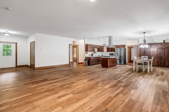 66 Mcnally Rd, Clinton, ME 04927 - living area featuring light wood-style flooring, a chandelier, and baseboards