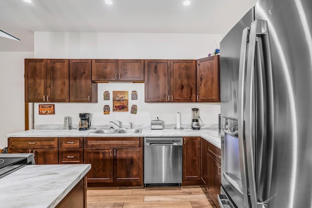 66 Mcnally Rd, Clinton, ME 04927 - kitchen with stainless steel appliances, a sink, light wood-style floors, recessed lighting, and light stone countertops