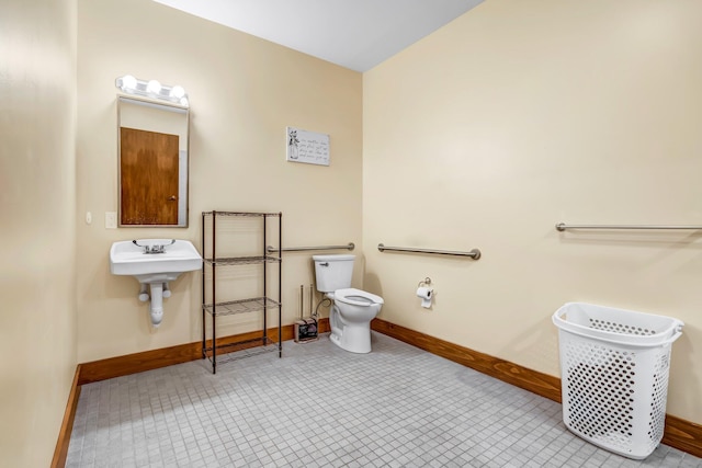 66 Mcnally Rd, Clinton, ME 04927 - bathroom with baseboards, toilet, and tile patterned flooring