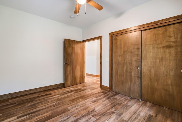 66 Mcnally Rd, Clinton, ME 04927 - unfurnished bedroom with wood finished floors, a closet, and a ceiling fan