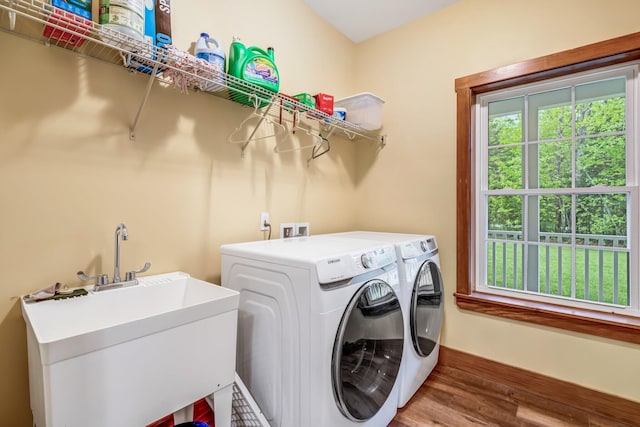 66 Mcnally Rd, Clinton, ME 04927 - laundry area featuring washing machine and dryer, healthy amount of natural light, wood finished floors, and baseboards