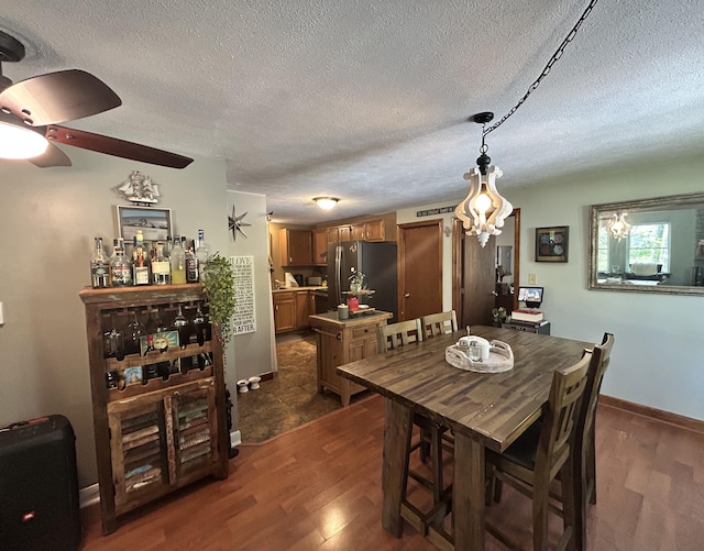 208 New Rd, Arundel, ME 04046 - dining area with dark wood finished floors, a textured ceiling, and a ceiling fan