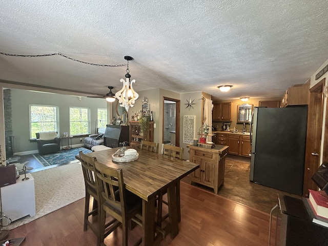 208 New Rd, Arundel, ME 04046 - dining area with dark wood-style floors, a chandelier, and a textured ceiling