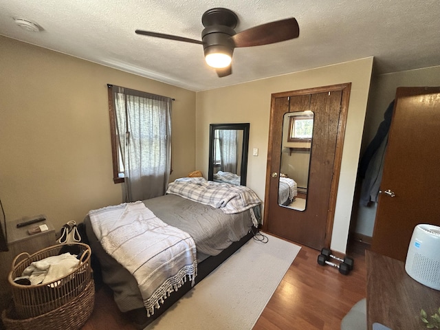208 New Rd, Arundel, ME 04046 - bedroom with wood finished floors, a textured ceiling, and ceiling fan