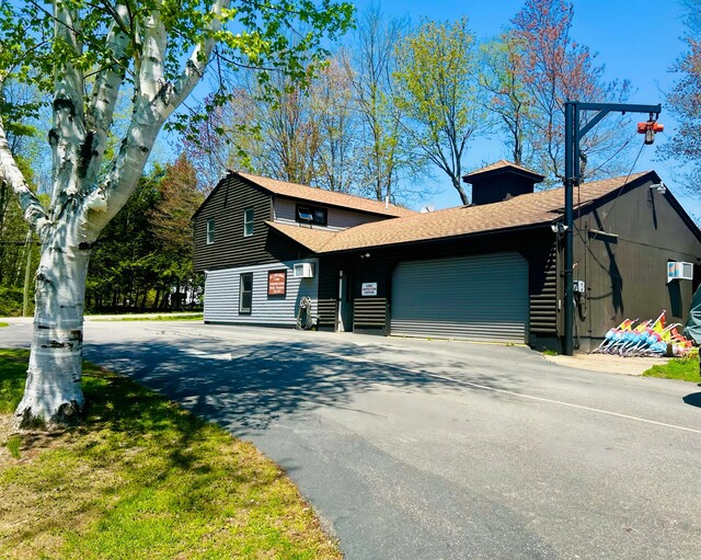 208 New Rd, Arundel, ME 04046 - view of front facade with asphalt driveway, a garage, and a shingled roof