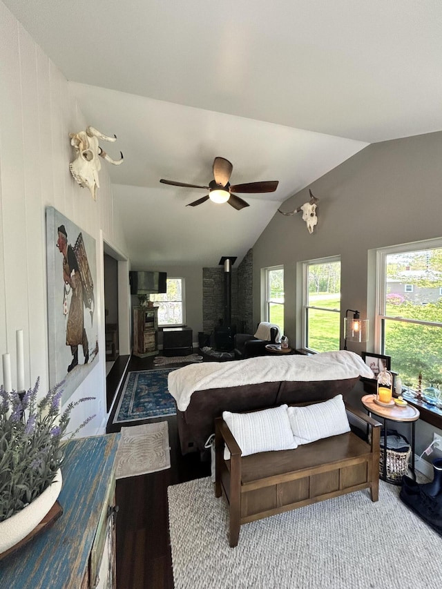 208 New Rd, Arundel, ME 04046 - bedroom with a wood stove, vaulted ceiling, and ceiling fan