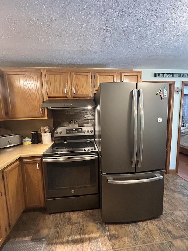 208 New Rd, Arundel, ME 04046 - kitchen with appliances with stainless steel finishes, under cabinet range hood, light countertops, brown cabinets, and a textured ceiling