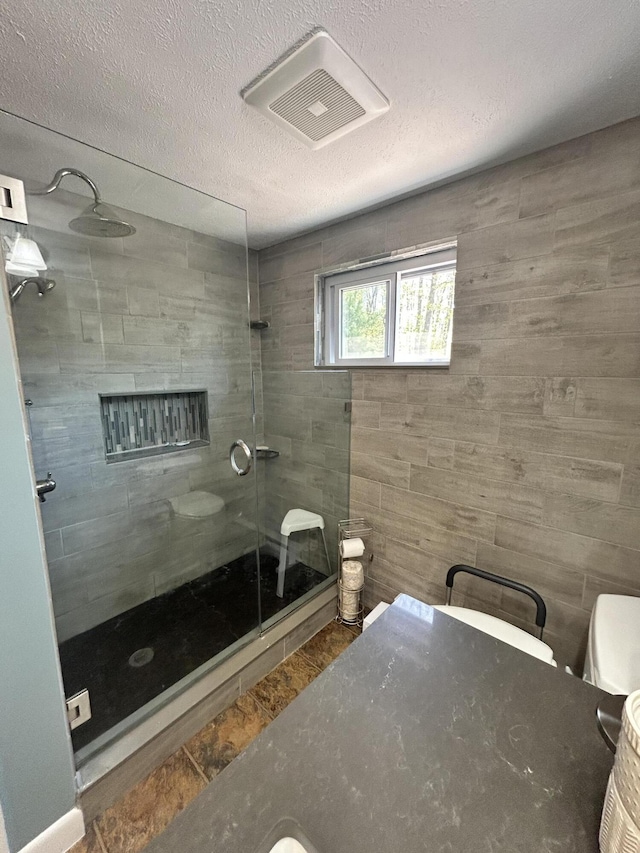 208 New Rd, Arundel, ME 04046 - bathroom featuring a walk in shower, toilet, and a textured ceiling