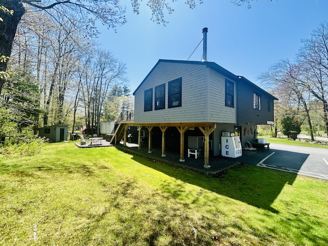 208 New Rd, Arundel, ME 04046 - rear view of property featuring a lawn, stairway, and a wooden deck