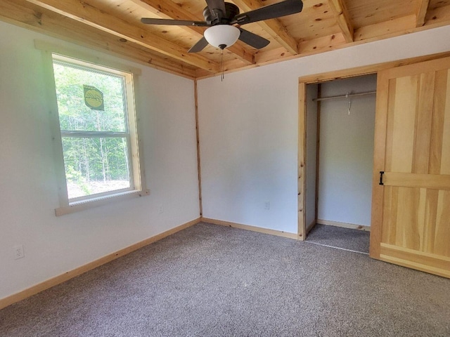 147 Keep Rd, Jay, ME 04239 - unfurnished bedroom featuring wooden ceiling with exposed beams, carpet flooring, baseboards, a closet, and ceiling fan