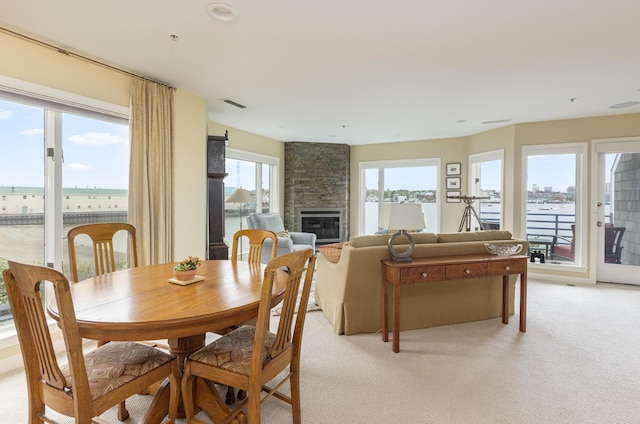 215 High St Unit 101, South Portland, ME 04106 - dining area featuring a large fireplace and light carpet