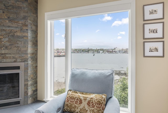 215 High St Unit 101, South Portland, ME 04106 - sitting room featuring a water view, healthy amount of natural light, and a glass covered fireplace