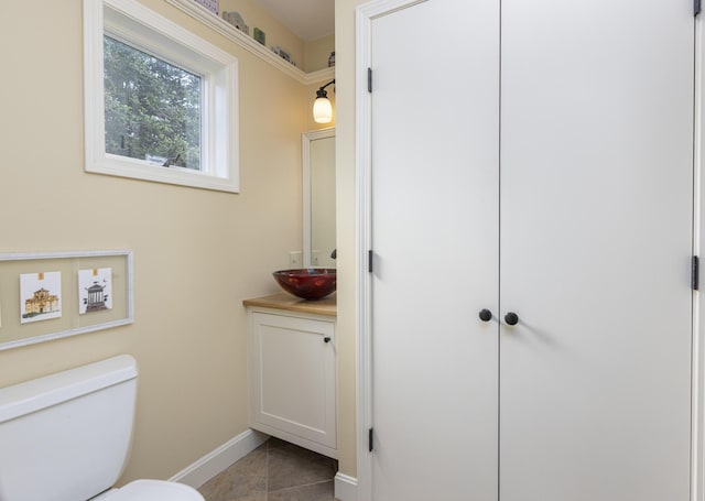 215 High St Unit 101, South Portland, ME 04106 - bathroom featuring baseboards, toilet, vanity, and tile patterned floors