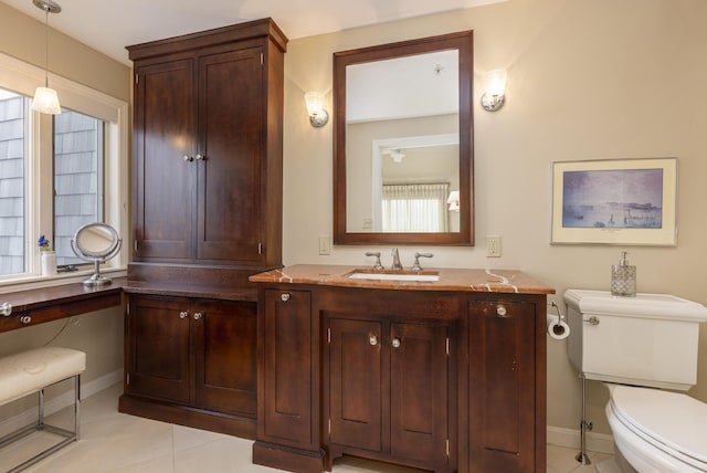 215 High St Unit 101, South Portland, ME 04106 - bathroom with toilet, tile patterned flooring, vanity, and baseboards