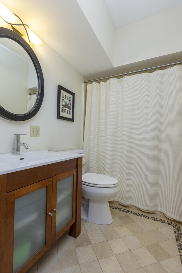 215 High St Unit 101, South Portland, ME 04106 - bathroom with vanity, toilet, and tile patterned flooring